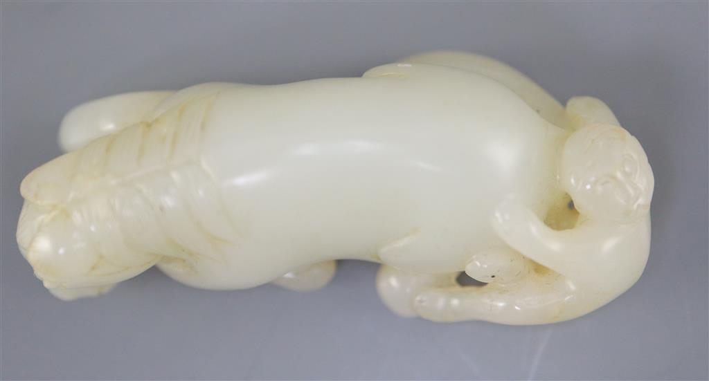 A Chinese white jade group of a recumbent horse and boy, 6cm long